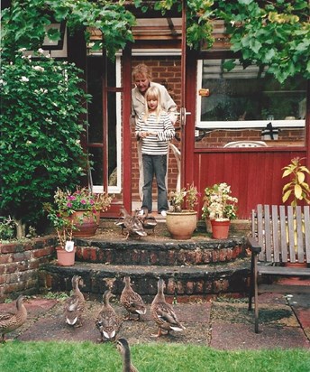 Nancy and Hannah feeding the ducks in the back garden in Bourne End