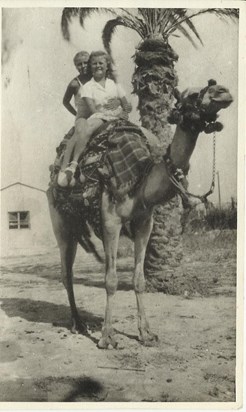 Mum taking a Camel ride with a friend