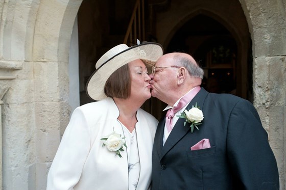 Mum and Dad sharing a kiss at our wedding