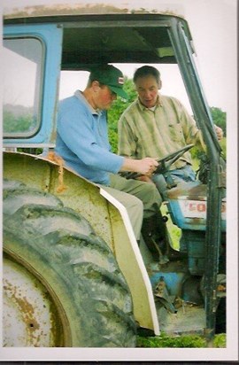 Ian teaching K(Millelium Farm Trust) tractor driving (from Bernadette)