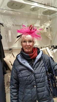 Mum having fun trying hats on for the wedding.