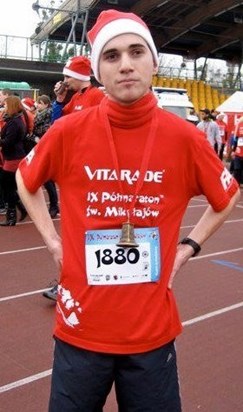 After his half marathon in Poland, wearing his victory christmas bell! :)