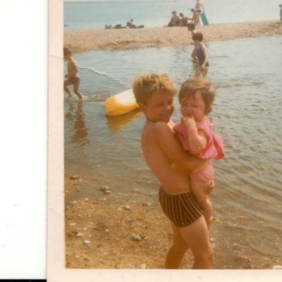 Mark holding Donna at the seaside