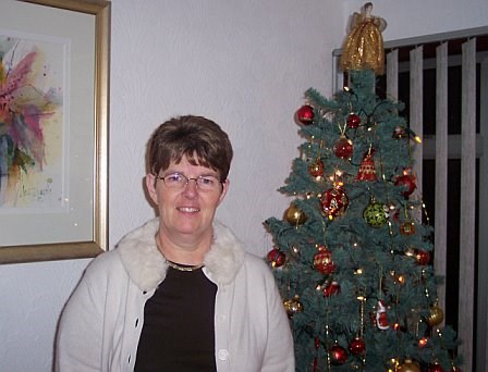 Mum in front of the Christmas tree