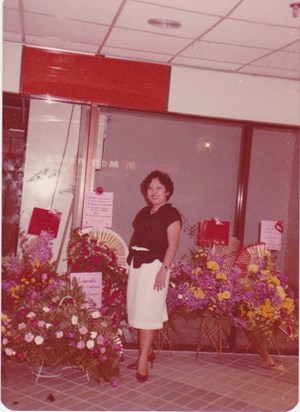 Surrounded by baskets of flowers, lucky girl!