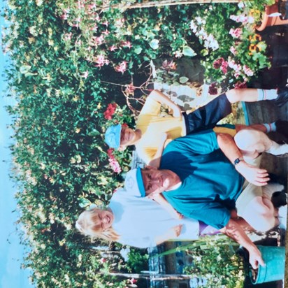 Rare picture of dad in shorts! Taken in Rivenhall, his beloved flowers , Kathryn and Jonathan.  