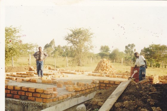 Working hard supervising the laying foundation of his home. Of great tenacity