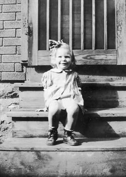 A young Ann Louise on steps