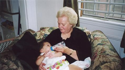 Ann Louise feeding her granddaughter Alexandra