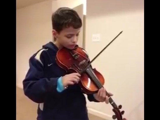 Caleb learning how to play violin.