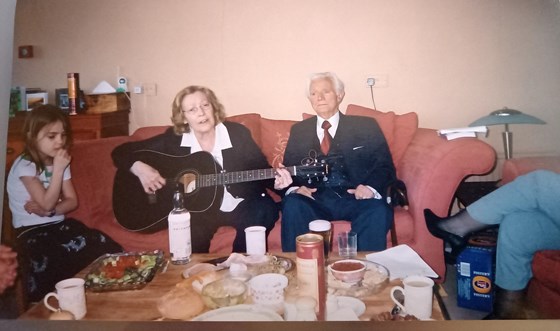 Sian, Nana jamming on her guitar & Grandad. Not sure whose legs...