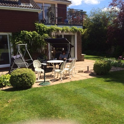 Sally reading in her garden on a beautiful day last year.