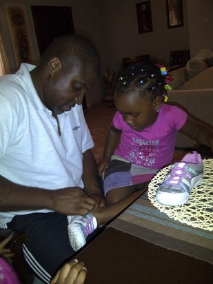 Uncle Ike putting Camela's shoes on