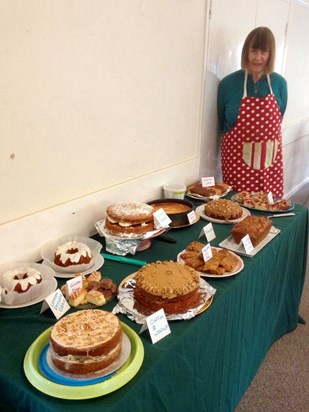 Monica with the array of cakes at the Coffee Morning, 2019.