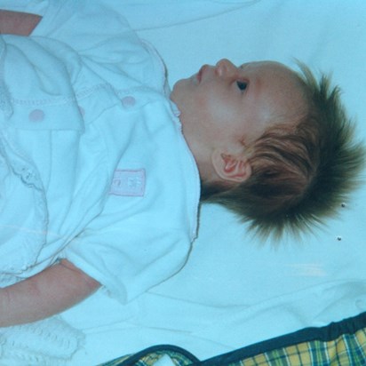 Eloise, at around 3 weeks old, with lots of spikey hair