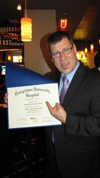 Tom receiving his GI Fellowship Diploma...doublechecking that it really is his diploma