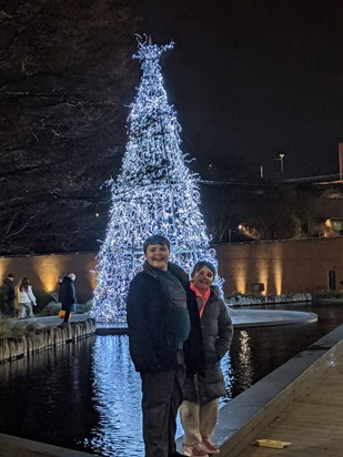 O and Lyla by the Christmas tree, wishing their grandad a happy Christmas