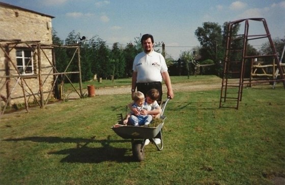 Special delivery? John having fun in the garden with his two boys