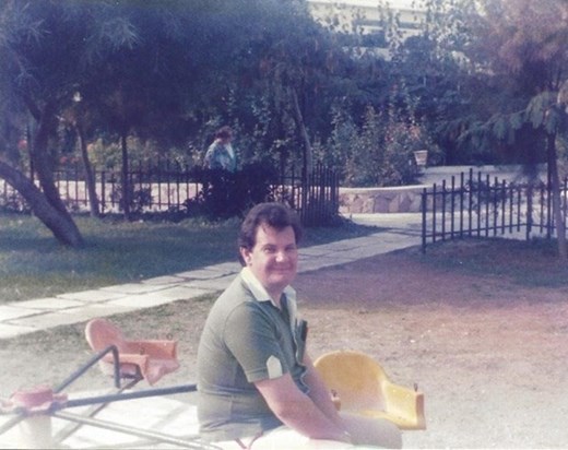 Who’s having more fun, me or the kids!? John smiles on a break from being Dad at the park. 