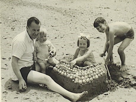 Fun on the beach (Devon?) with Dad, Mary & Anne. John just extending the moat to the sea