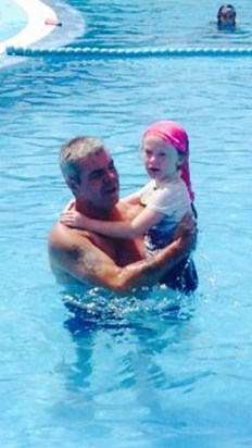 Grandad teaching Charlotte to swim on holiday 