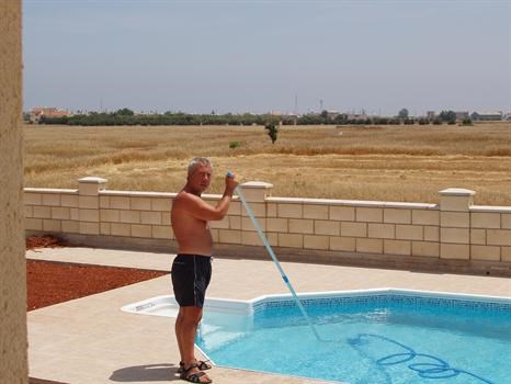 Mick cleaning pool