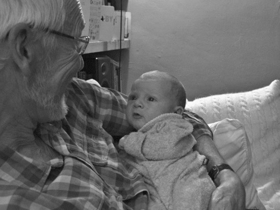 With his first grandchild, a couple of weeks old