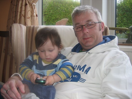 Edward & Uncle Ade. xxx  Edward is trying to work out Ade's mobile phone...oh the technology!!