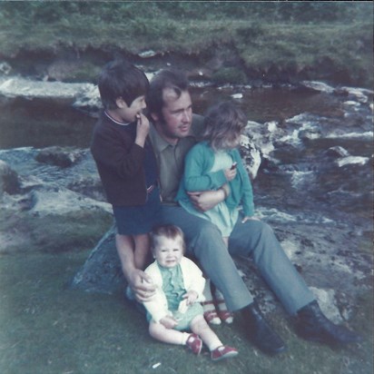 Dad and Children on rock by stream