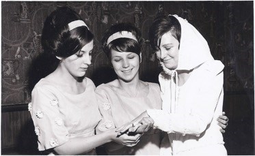 Maria and Janet admiring Marion's ring at her wedding in 1967