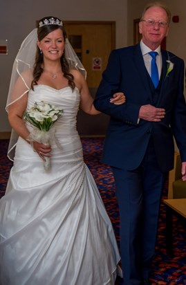 A proud moment for Dad, walking his daughter down the aisle. 