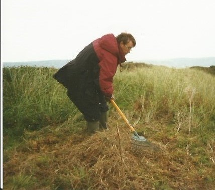 John raking grass