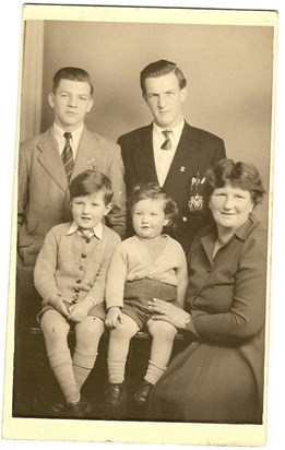 Michael pictured here aged around 16 back left with brother John and his mum and his half brothers
