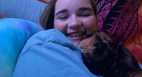 Loving on Selena her Guinea Pig. They loved her as much as she loved them. 