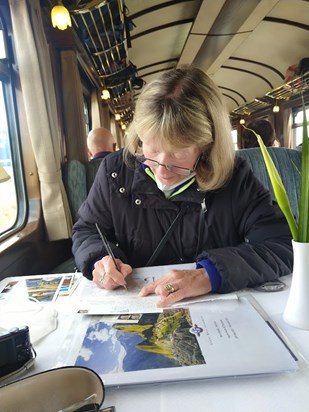 Writing postcards to home on the train. Peru, June 2022.