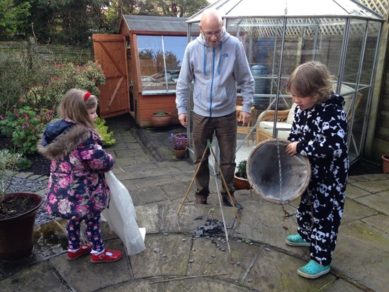 Gardening. Of course, he's gardening. With little helpers!