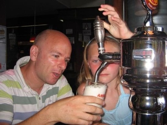Showing Mackenzie how to pull the perfect pint - Spain 2008
