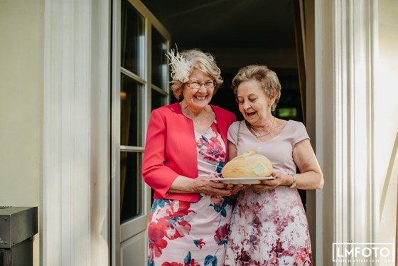 Mum with Anna's mum performing a Polish wedding tradition