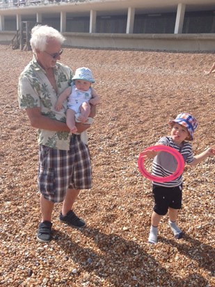 Cliff in his favourite shirt, on the beach, with the Grandchildren