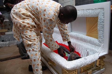 Son placing Father in Casket