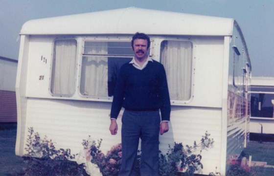 Dad standing in front of our caravan at Blue Anchor Bay