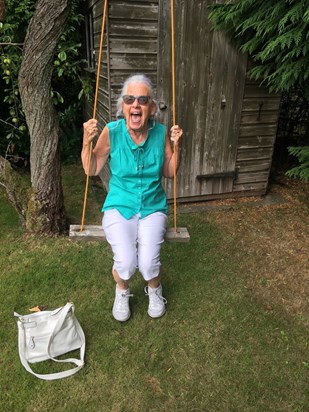 Mum in our back garden, loving our swing!