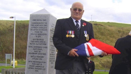 Dad with the ensign that had been flying on the Royal Oak for 1 year...