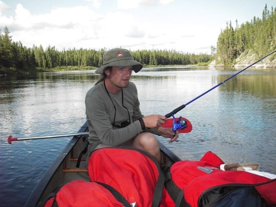 On a canoeing trip in Canada. [He went with his friend, John.]