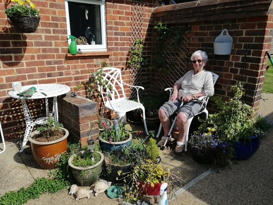 Grace sitting in the sun at Hedgers 