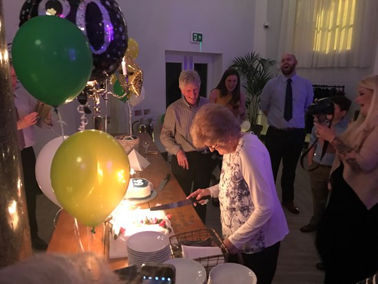 Cutting the cake at the surprise birthday party