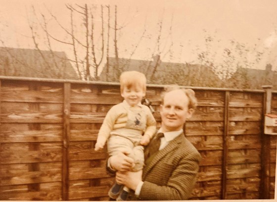 Dad proudly holding Mark aloft