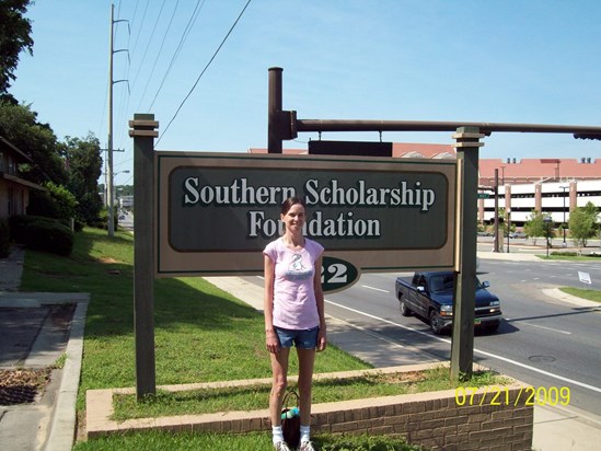 Debbie in front of the scholarship house 2009
