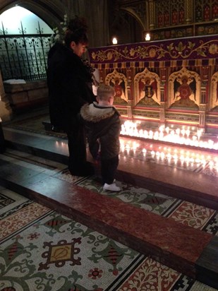 Jamie's mum Gina and nephew Teddy lighting a candle in memory of jamie and st Marys church memorial