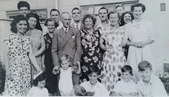 Derek (back row, left) with the Adams family, grandparents, parents, sister, uncles, aunts, and cousins